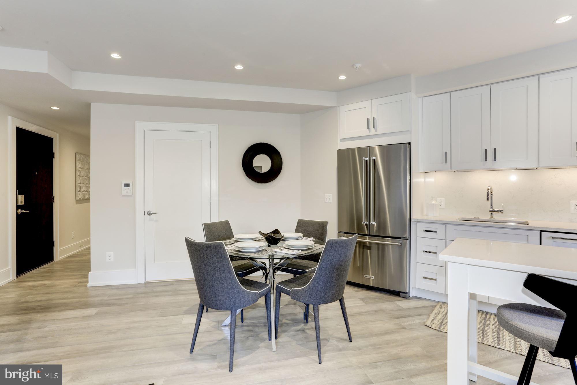 2434 16th Street Northwest, Unit 301 Washington, DC 20009 - Photo 11 of 30 a kitchen with stainless steel appliances granite countertop a refrigerator and a stove top oven