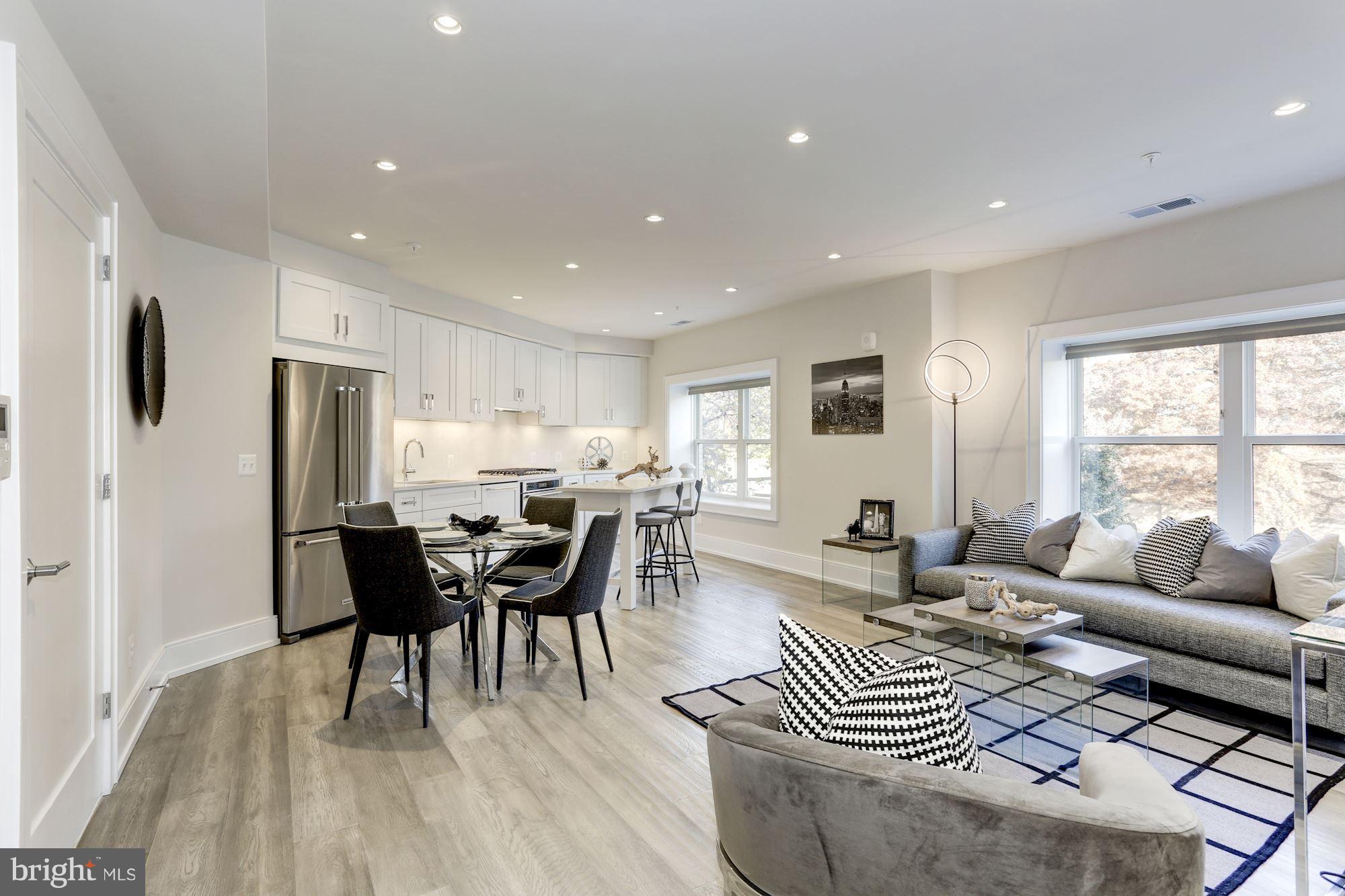 2434 16th Street Northwest, Unit 301 Washington, DC 20009 - Photo 12 of 30 a living room with furniture a wooden floor and a window