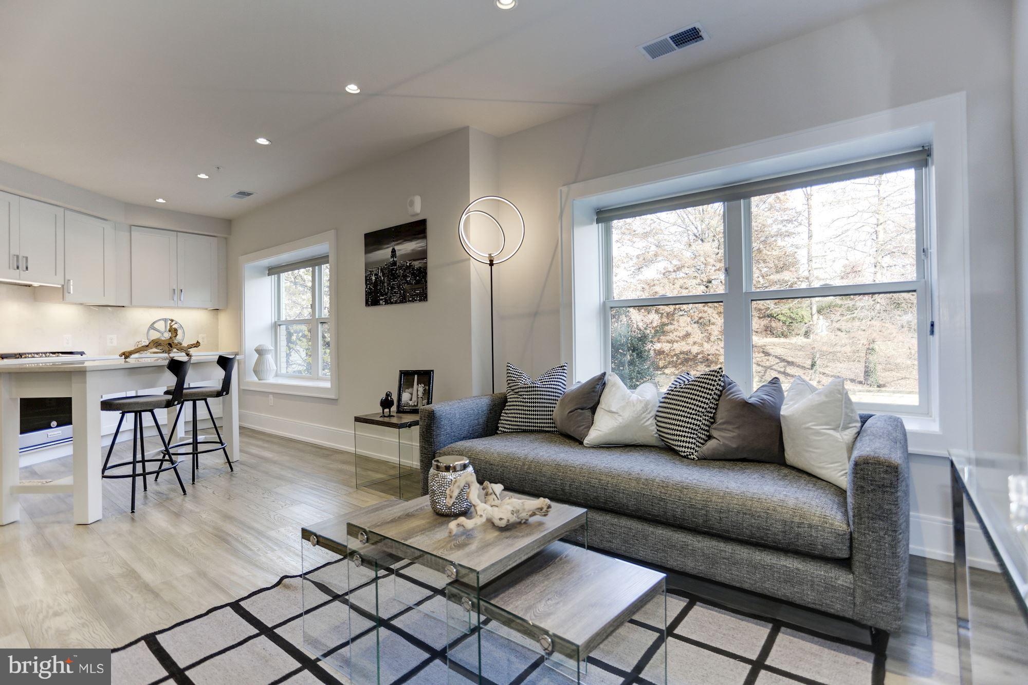 2434 16th Street Northwest, Unit 301 Washington, DC 20009 - Photo 13 of 30 a living room with furniture and a large window