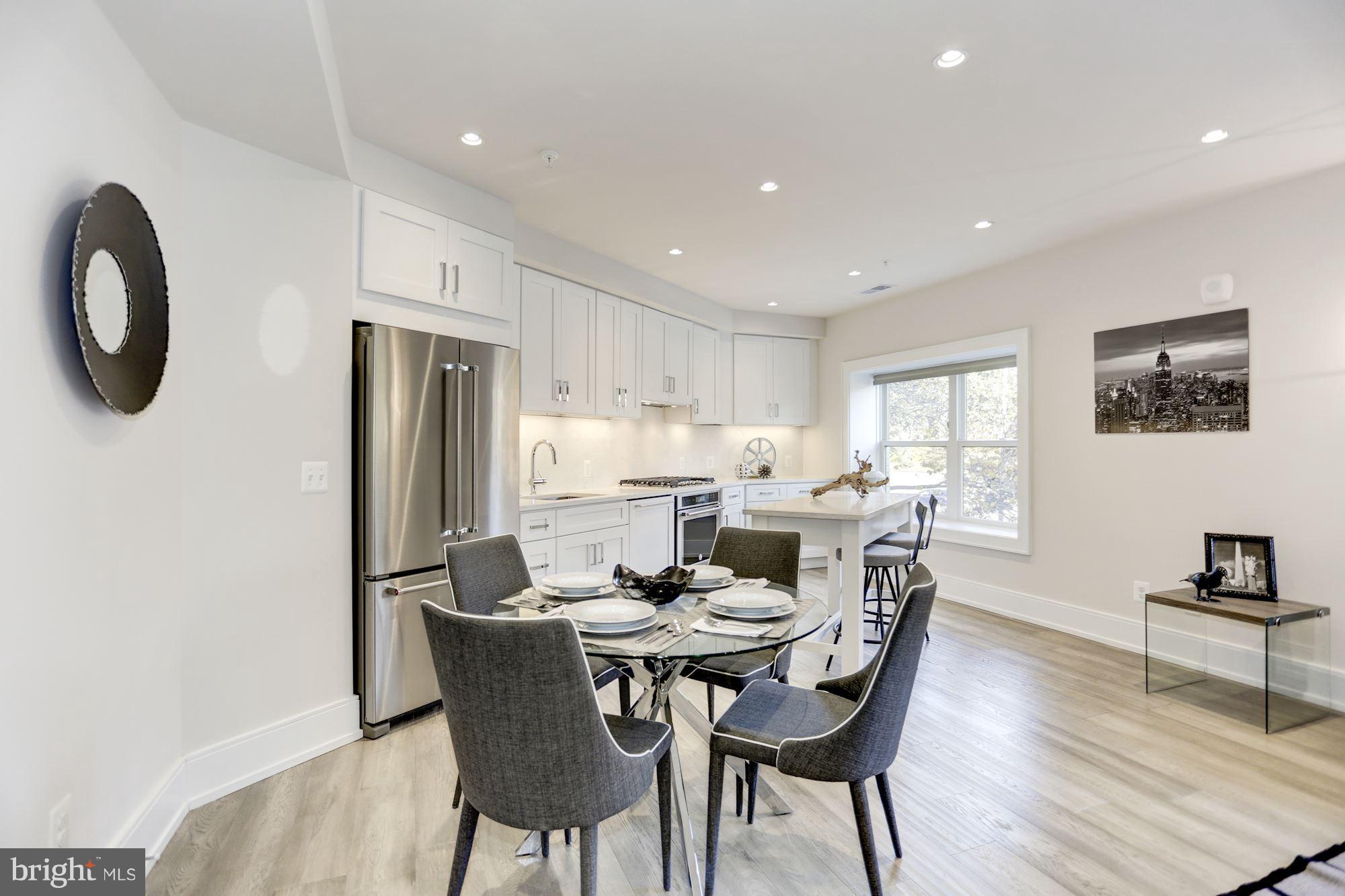 2434 16th Street Northwest, Unit 301 Washington, DC 20009 - Photo 14 of 30 a dining room with furniture a window and wooden floor