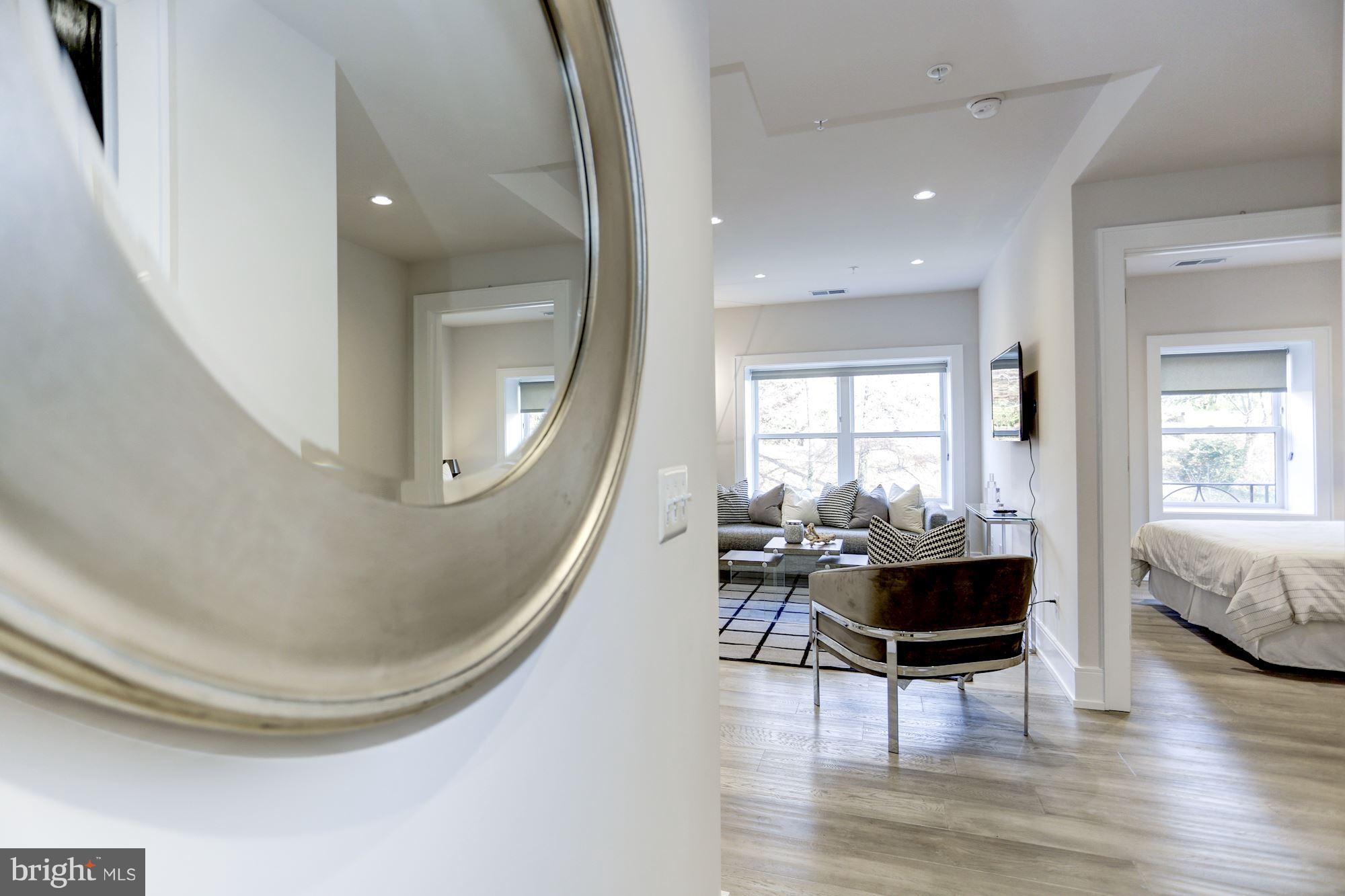 2434 16th Street Northwest, Unit 301 Washington, DC 20009 - Photo 15 of 30 a living room with furniture and a large window
