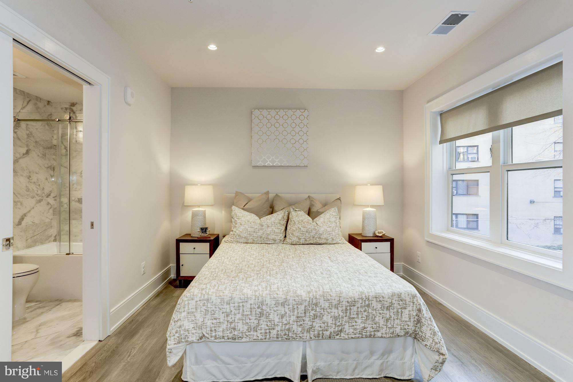 2434 16th Street Northwest, Unit 301 Washington, DC 20009 - Photo 18 of 30 a bedroom with a bed and a window