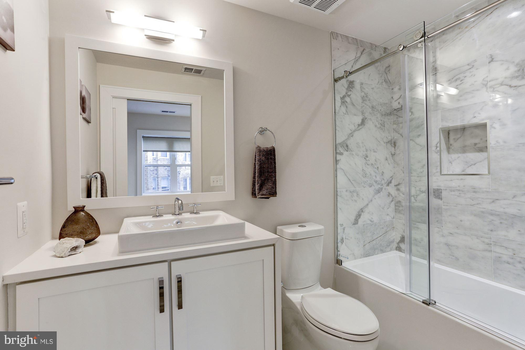 2434 16th Street Northwest, Unit 301 Washington, DC 20009 - Photo 22 of 30 a bathroom with a sink toilet and shower