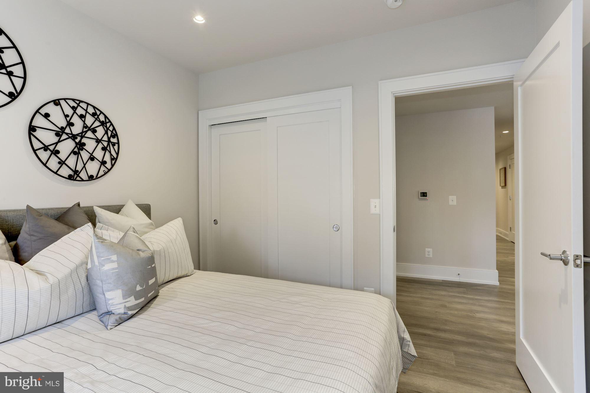 2434 16th Street Northwest, Unit 301 Washington, DC 20009 - Photo 24 of 30 a bedroom with a bed and a table