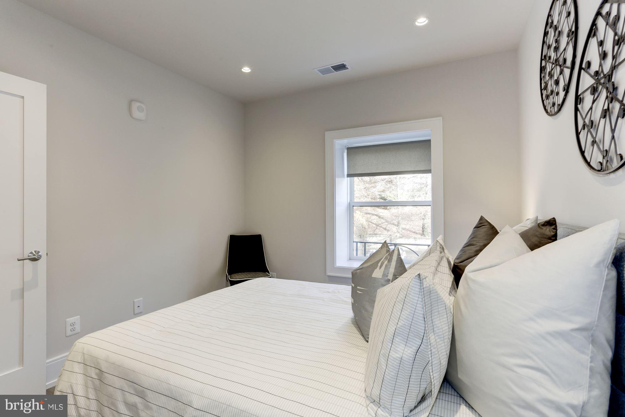 2434 16th Street Northwest, Unit 301 Washington, DC 20009 - Photo 25 of 30 a bedroom with a bed and a window