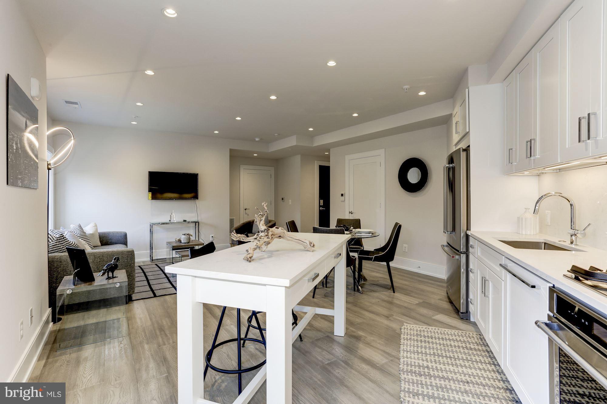 2434 16th Street Northwest, Unit 301 Washington, DC 20009 - Photo 10 of 30 a view of kitchen with stainless steel appliances granite countertop a sink and a stove