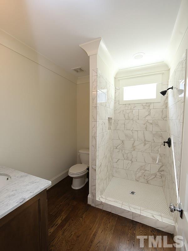 2004 Wiggs Street Raleigh, NC 27608 - Photo 15 of 25 a bathroom with a shower and a toilet
