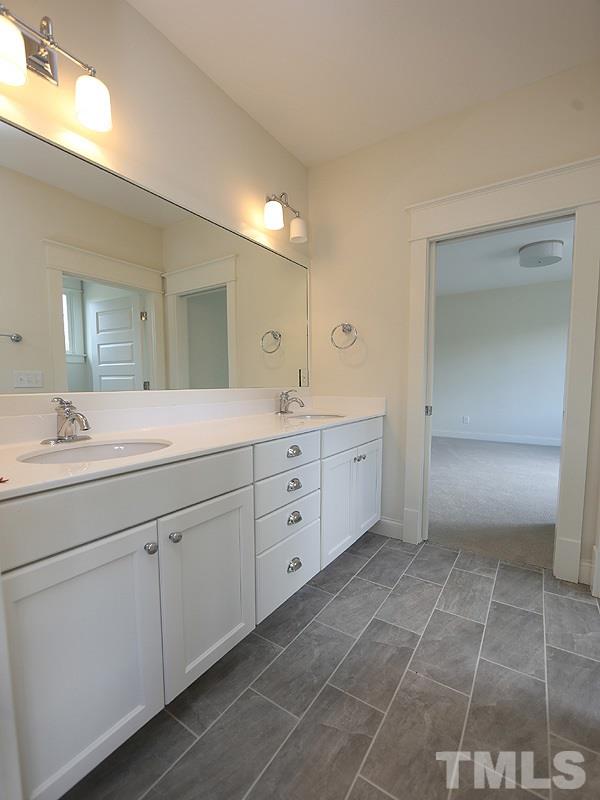 2004 Wiggs Street Raleigh, NC 27608 - Photo 21 of 25 a spacious bathroom with a granite countertop sink a mirror and a