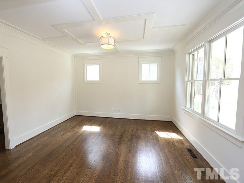 2004 Wiggs Street Raleigh, NC 27608 - Photo 4 of 25 an empty room with wooden floor and windows