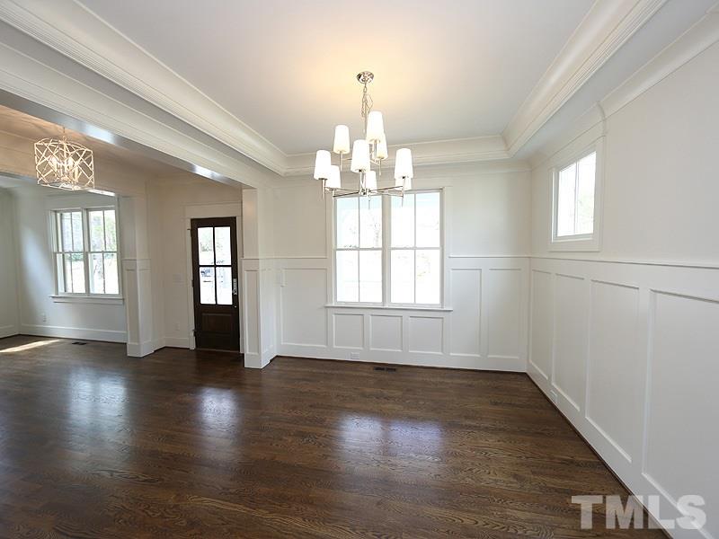2004 Wiggs Street Raleigh, NC 27608 - Photo 5 of 25 an empty room with wooden floor and windows
