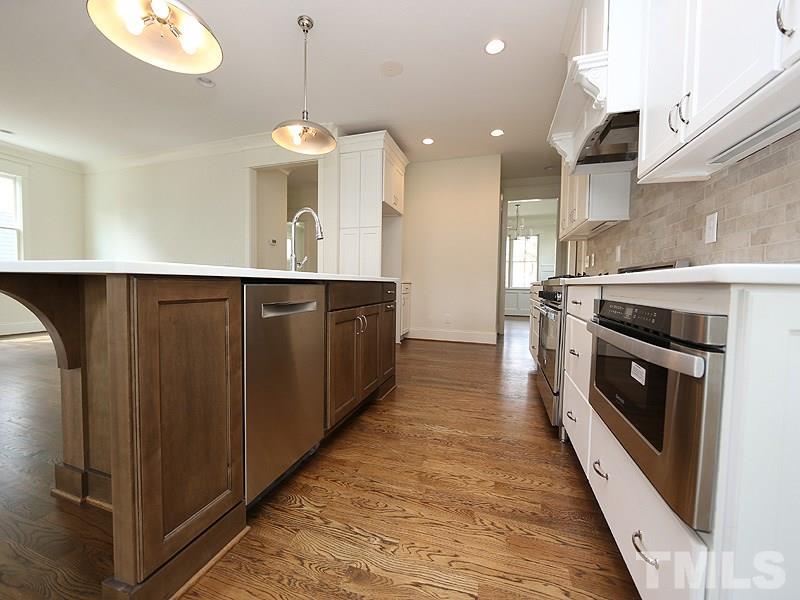 2004 Wiggs Street Raleigh, NC 27608 - Photo 10 of 25 a large kitchen with stainless steel appliances granite countertop a stove a sink and a refrigerator