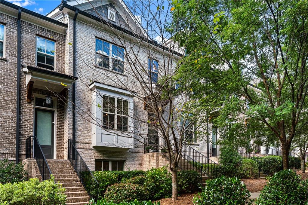 a front view of a multi story building with yard