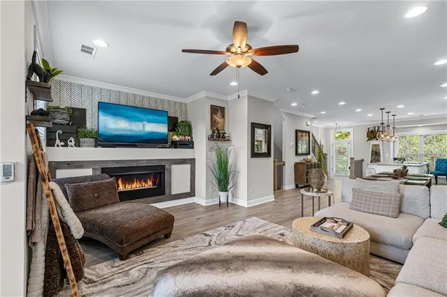 a living room with furniture a flat screen tv and a fireplace