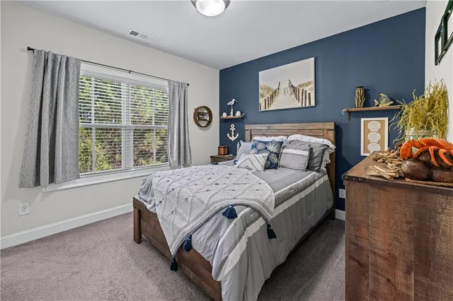 a bedroom with bed and a window