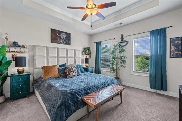 a bedroom with a large bed and a chandelier