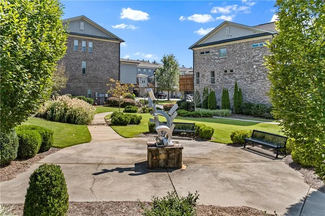 a view of a chair and table in backyard of the house