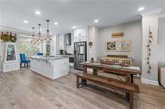 a living room with furniture and a kitchen view