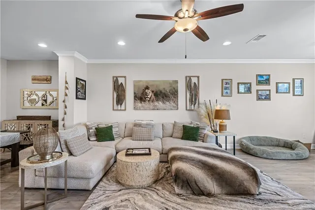 a living room with furniture and a ceiling fan