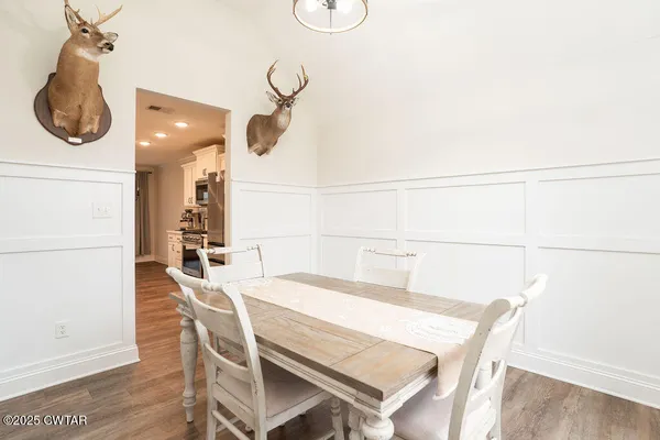 a dining room with a table and chairs