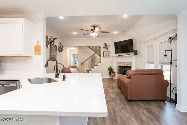 a living room with furniture a flat screen tv and a fireplace