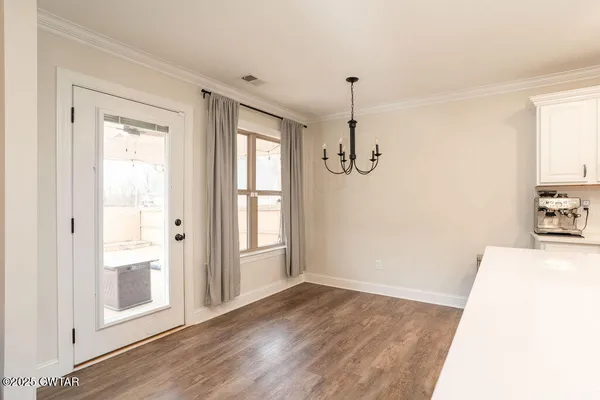 a view of a room with wooden floor and windows