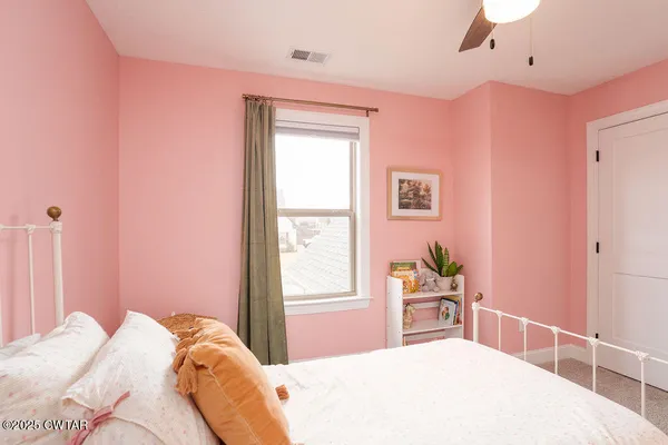 a bedroom with a bed and a window