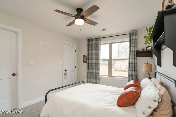 a bedroom with a large bed and a tv