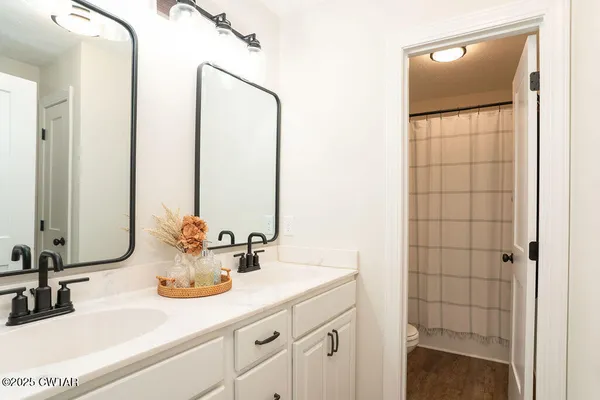 a bathroom with a double vanity sink and a mirror