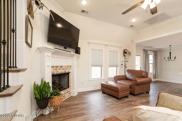 a living room with furniture fireplace and flat screen tv
