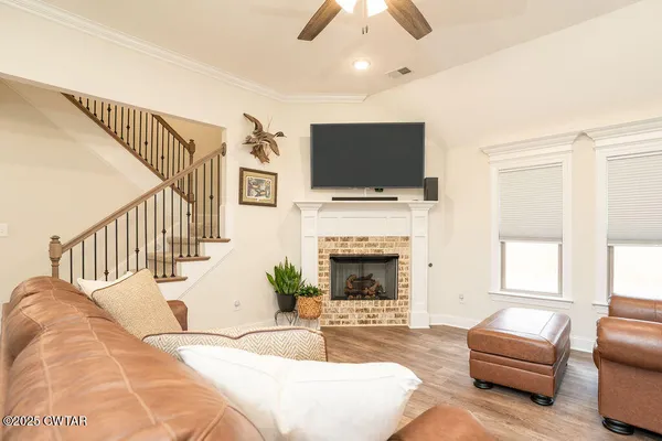 a living room with furniture fireplace and flat screen tv