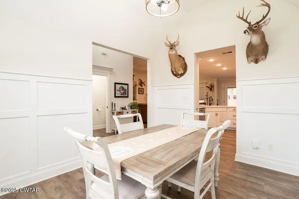 a dining room with furniture and a mirror