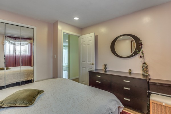 34 Westgate Road, Unit 5 Boston, MA 02467 - Photo 11 of 18 a bedroom with a bed and a double vanity sink