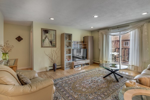 34 Westgate Road, Unit 5 Boston, MA 02467 - Photo 3 of 18 a living room with furniture a window and gym equipment