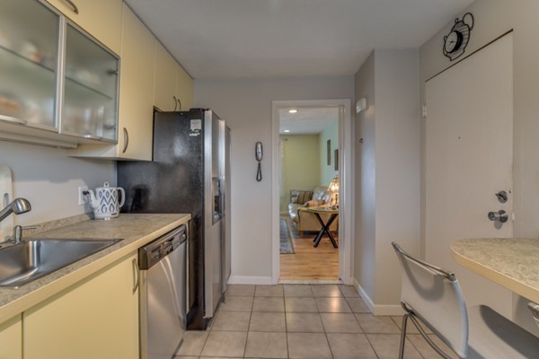 34 Westgate Road, Unit 5 Boston, MA 02467 - Photo 8 of 18 a kitchen with a sink a refrigerator and a sink