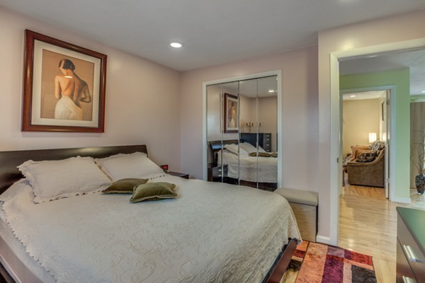 34 Westgate Road, Unit 5 Boston, MA 02467 - Photo 10 of 18 a bedroom with a bed and a view of en suite bathroom
