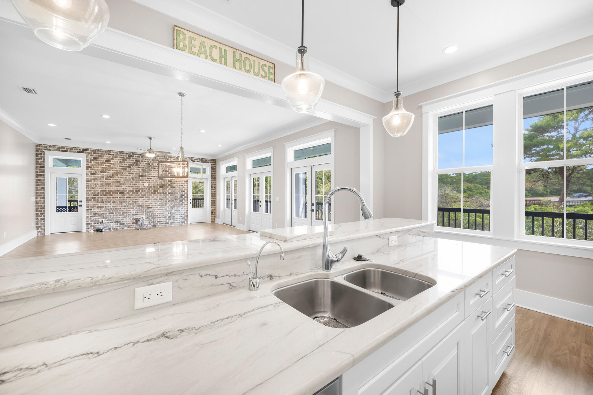 61 Blue Lake Road Santa Rosa Beach, FL 32459 - Photo 16 of 66 a kitchen with a sink a counter space and a chandelier