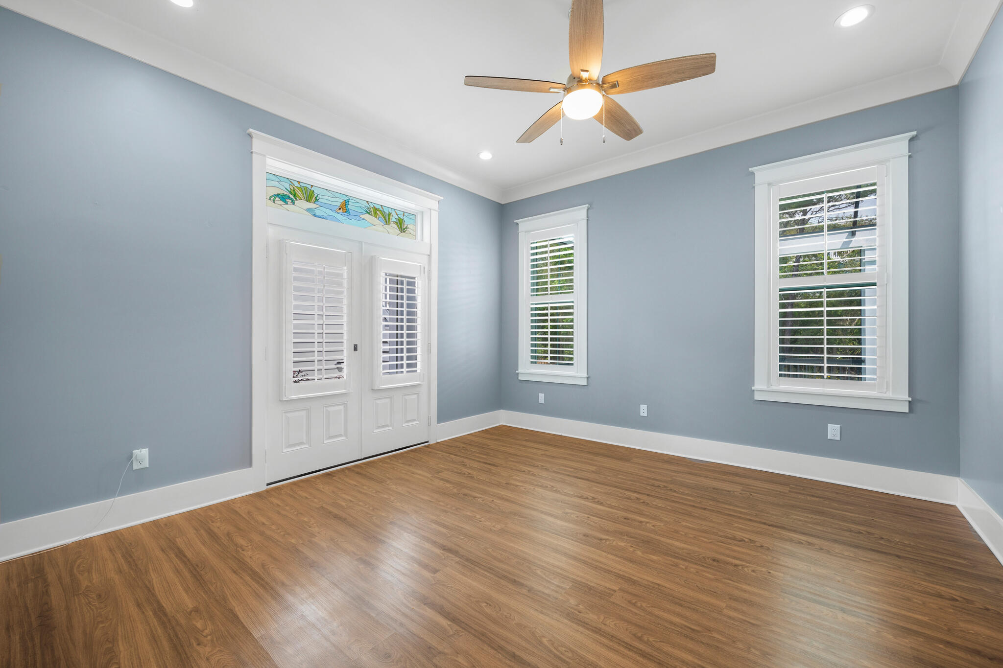 61 Blue Lake Road Santa Rosa Beach, FL 32459 - Photo 18 of 66 a view of an empty room with a window and wooden floor