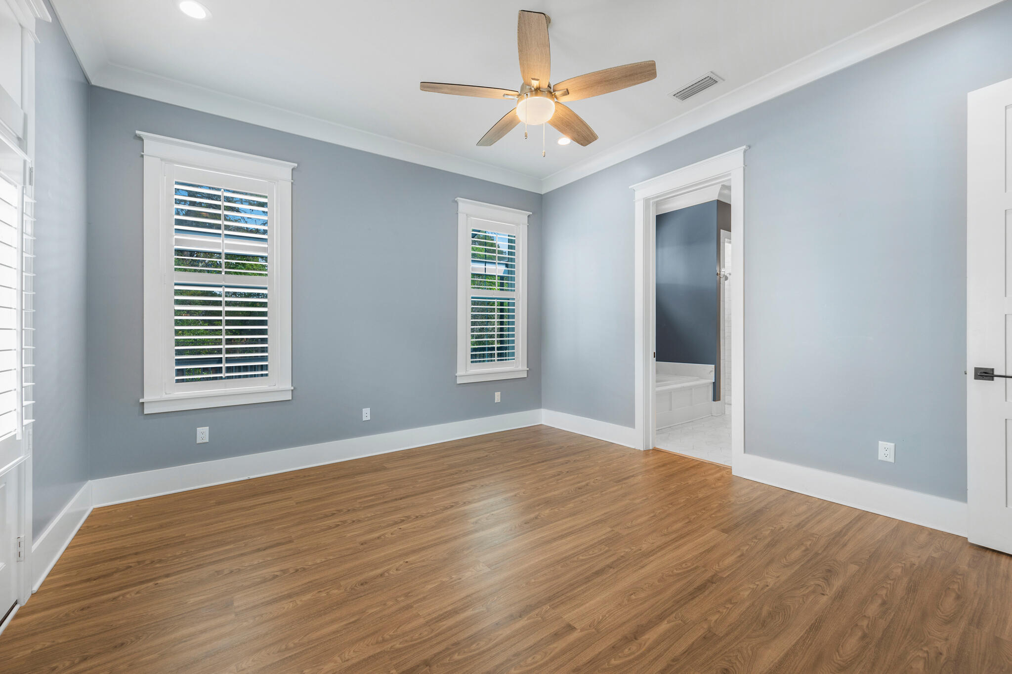 61 Blue Lake Road Santa Rosa Beach, FL 32459 - Photo 19 of 66 a view of an empty room with window and wooden floor