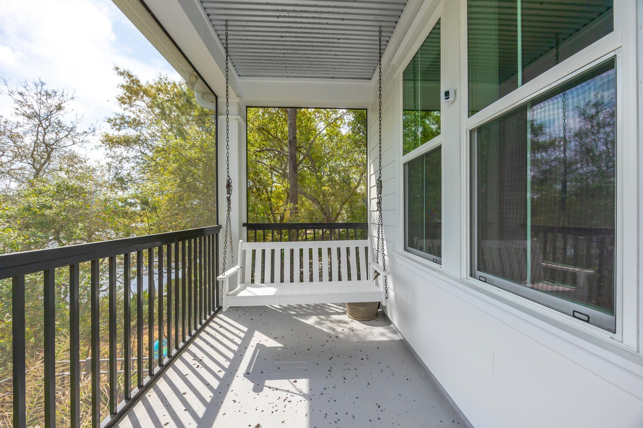 61 Blue Lake Road Santa Rosa Beach, FL 32459 - Photo 37 of 66 a view of a wooden balcony with a floor to ceiling window