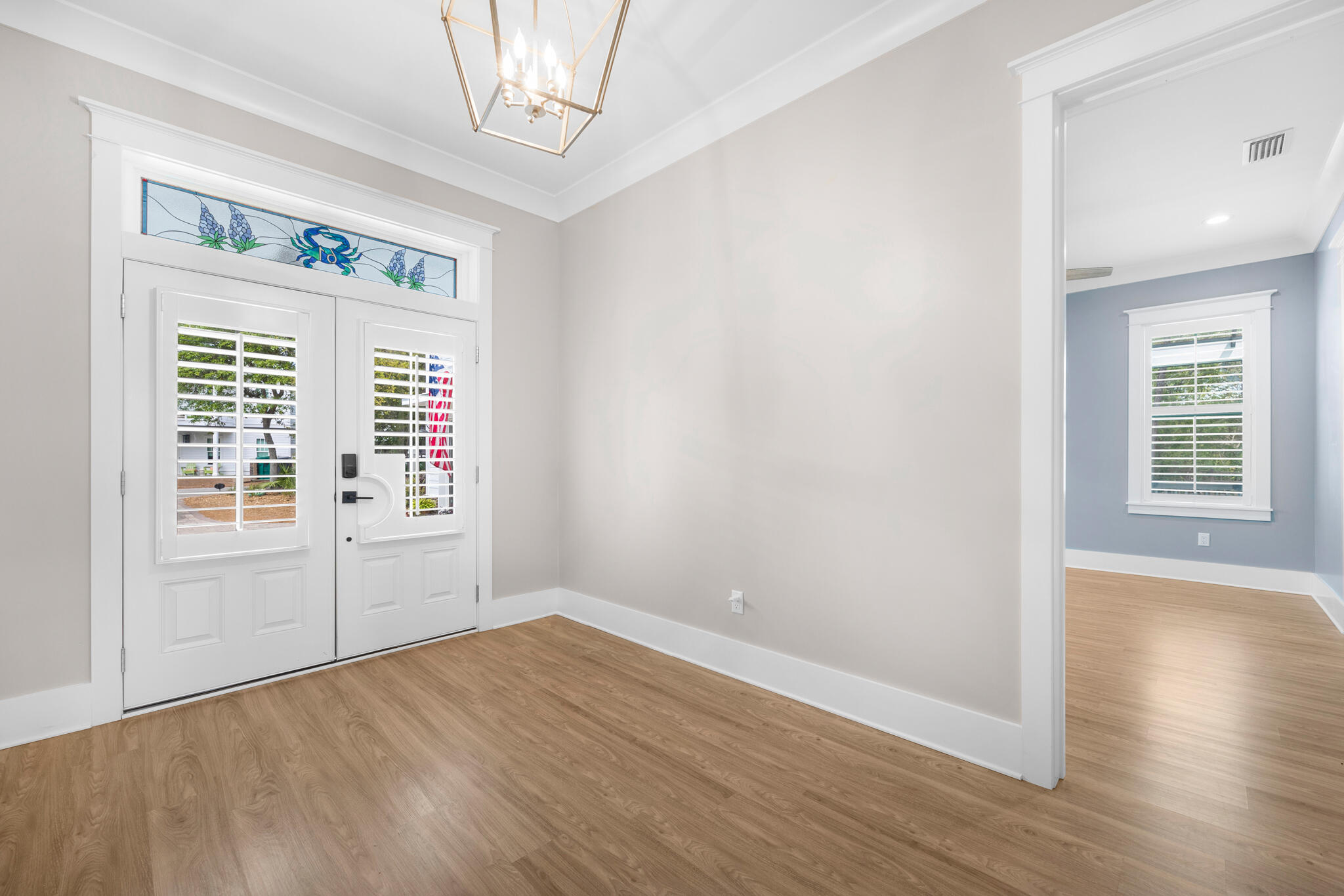 61 Blue Lake Road Santa Rosa Beach, FL 32459 - Photo 5 of 66 an empty room with wooden floor and windows