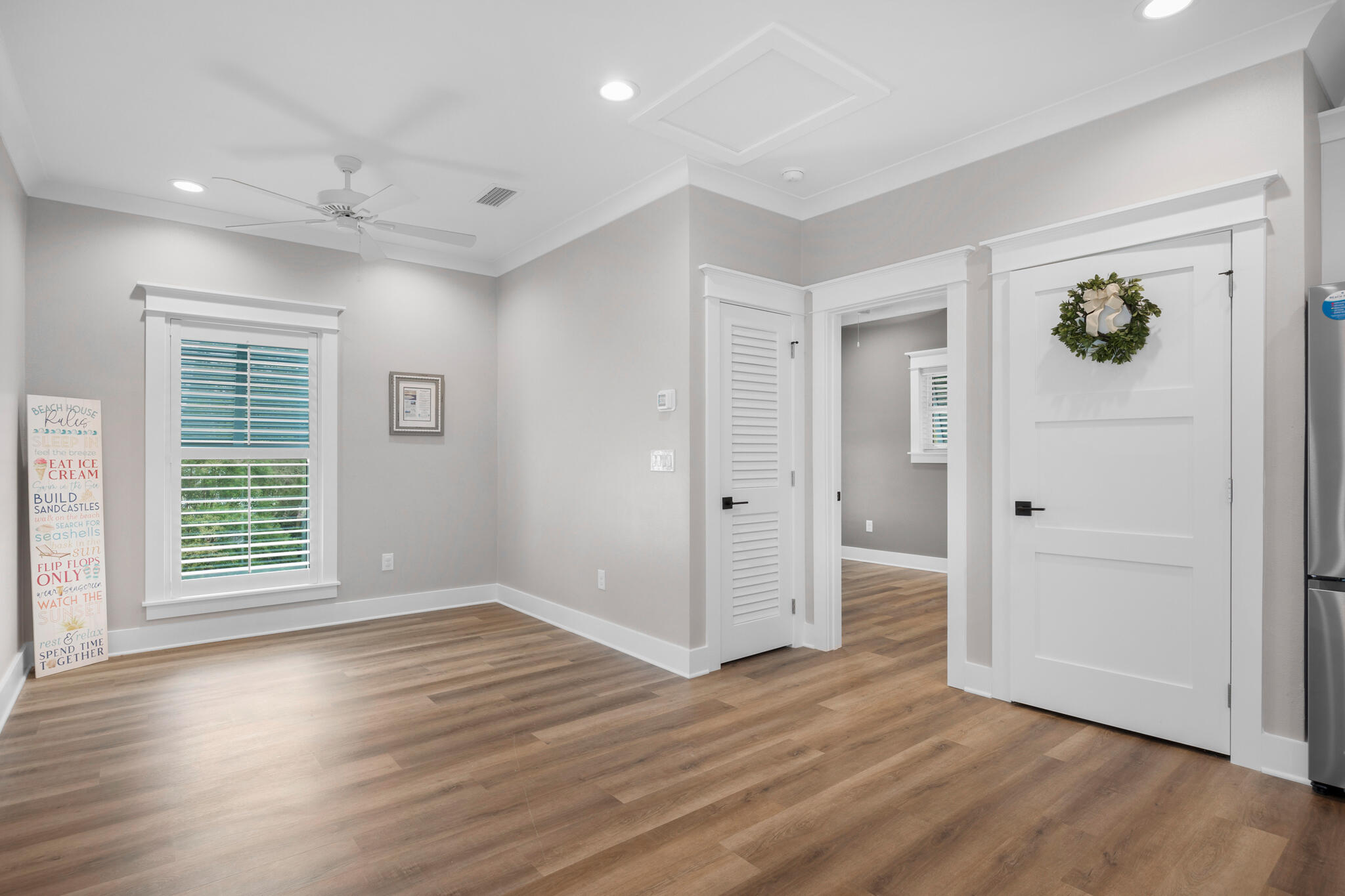 61 Blue Lake Road Santa Rosa Beach, FL 32459 - Photo 54 of 66 an empty room with wooden floor and windows