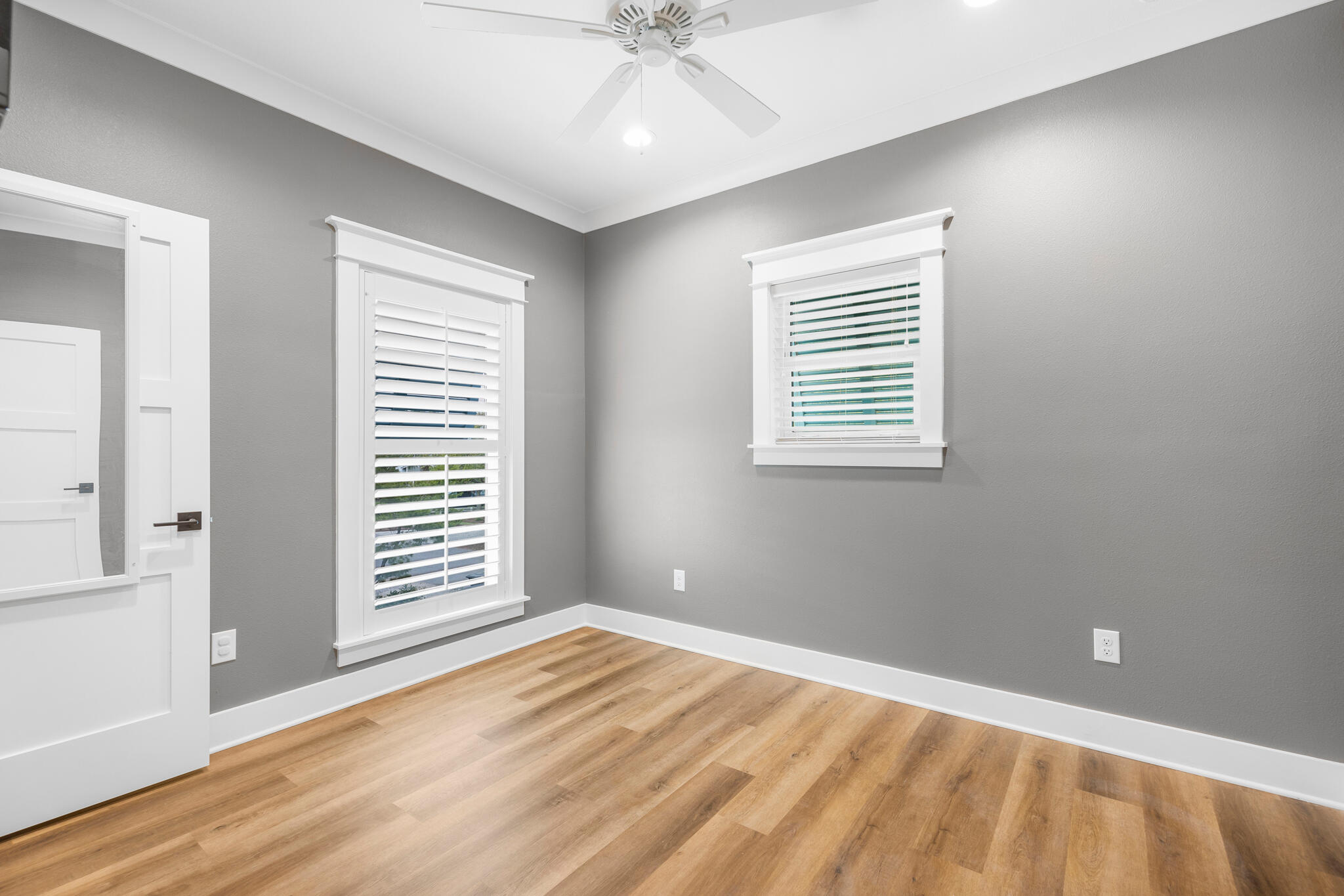 61 Blue Lake Road Santa Rosa Beach, FL 32459 - Photo 56 of 66 an empty room with wooden floor and windows