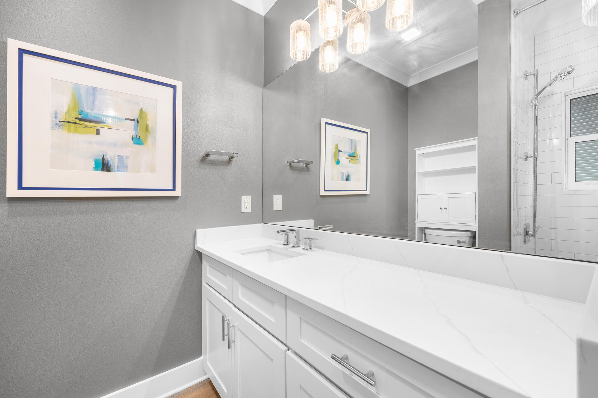 61 Blue Lake Road Santa Rosa Beach, FL 32459 - Photo 58 of 66 a bathroom with a sink a vanity and a painting on the wall