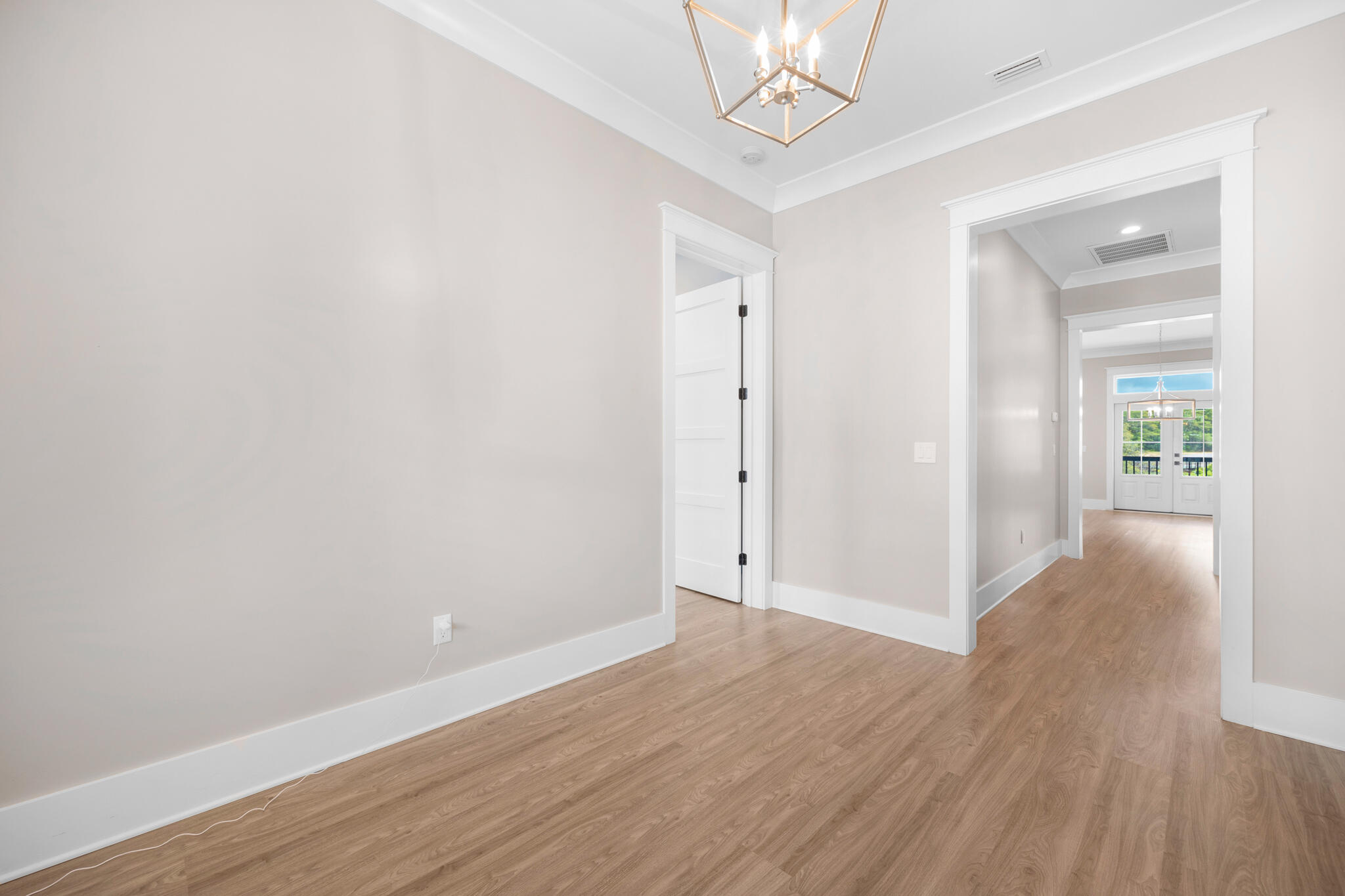 61 Blue Lake Road Santa Rosa Beach, FL 32459 - Photo 6 of 66 a view of an empty room with wooden floor