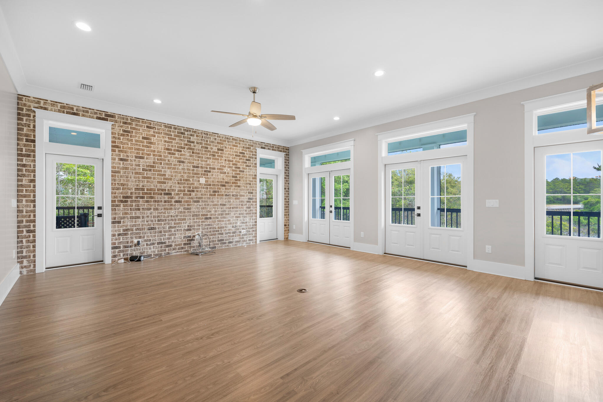 61 Blue Lake Road Santa Rosa Beach, FL 32459 - Photo 7 of 66 a view of an empty room with wooden floor and a window
