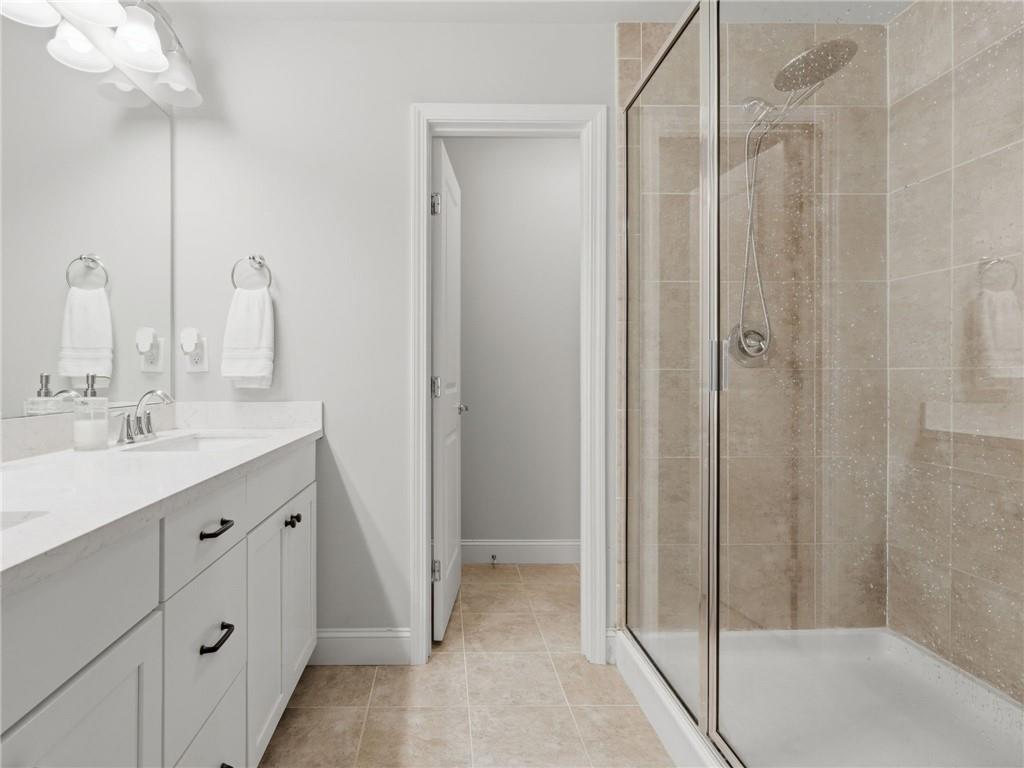 147 Fieldbrook Crossing Canton, GA 30115 - Photo 23 of 46 a bathroom with a double vanity sink mirror and shower