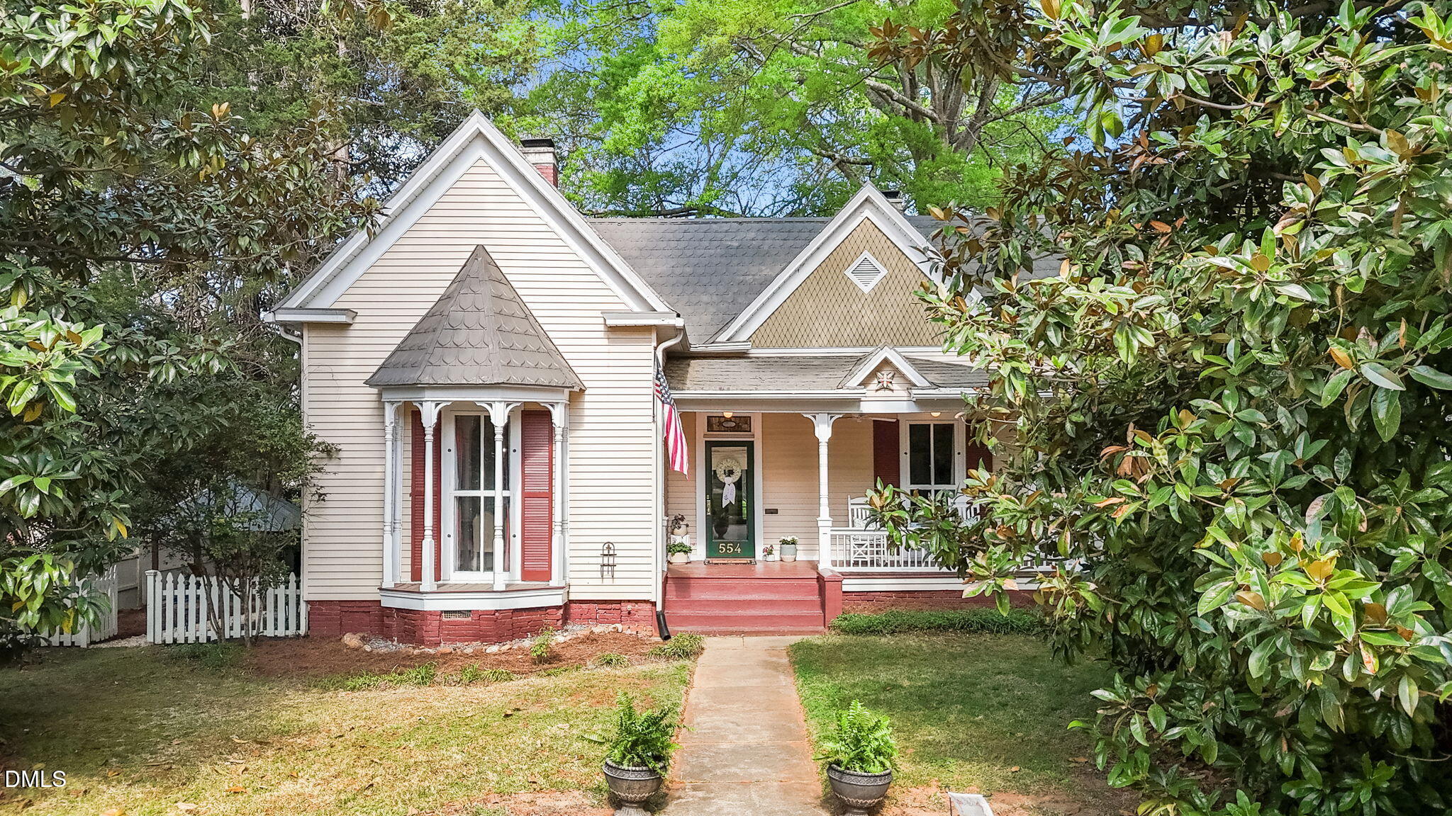 554 South Main Street Wake Forest, NC 27587 - Photo 4 of 78 a view of a brick house with a yard plants and large tree