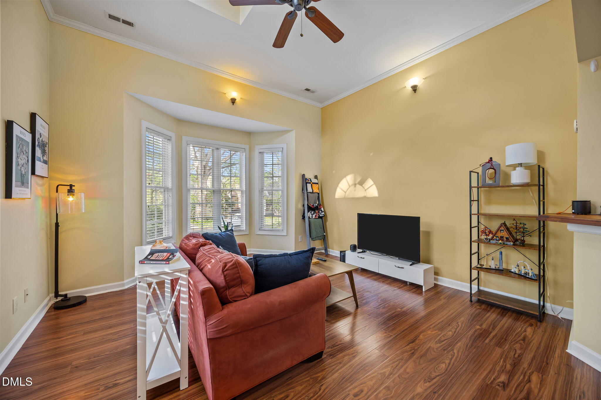 554 South Main Street Wake Forest, NC 27587 - Photo 59 of 78 a living room with furniture a flat screen tv and a floor to ceiling window