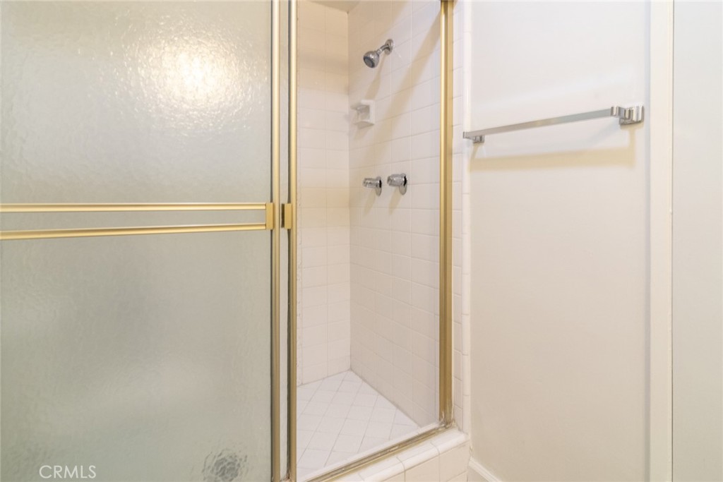 1122 9th Street, Unit 4 Santa Monica, CA 90403 - Photo 15 of 18 a bathroom with a glass shower door
