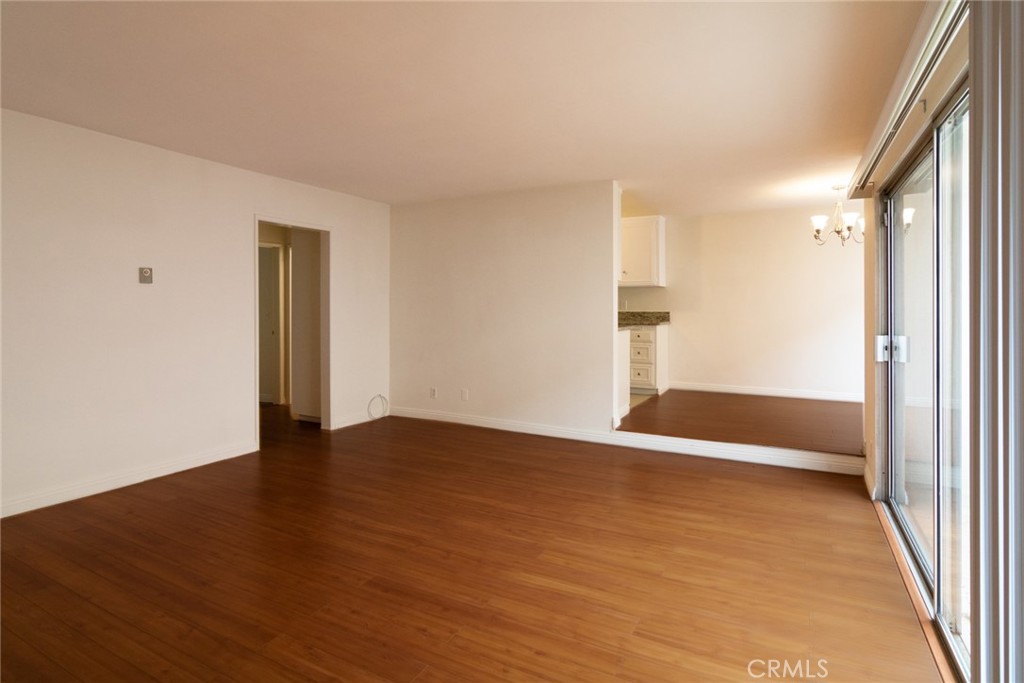 1122 9th Street, Unit 4 Santa Monica, CA 90403 - Photo 5 of 18 a view of an empty room with wooden floor and a window